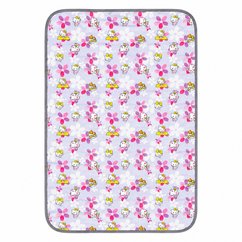A rectangular mat with rounded corners featuring a repeating Hello Kitty pattern on a light lavender background. The pattern includes pink flowers, white blossoms, and Hello Kitty characters in yellow, pink, and white.