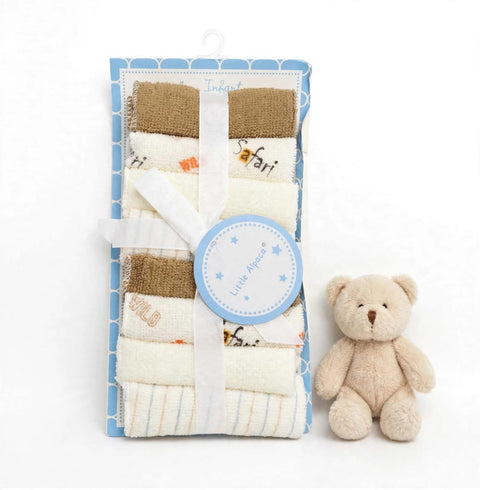 A packaged set of folded baby blankets or swaddle blankets in soft neutral tones, tied with a white ribbon and a round blue tag, displayed next to a small beige teddy bear on a white background.