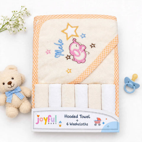 A set of six baby washcloths in a white cardboard package, featuring a hooded towel with orange gingham trim and embroidered details of a pink elephant, a yellow star, and the word 'Moe'. The set is displayed on a white background with a teddy bear, baby flowers, and a pacifier as props.