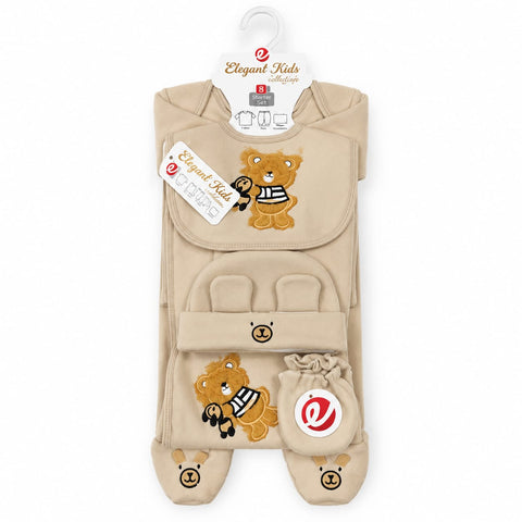 A baby footed sleeper set by Elegant Kids, featuring a beige bib, footed sleeper, and booties with embroidered teddy bear designs, hanging on a white hanger against a white background.