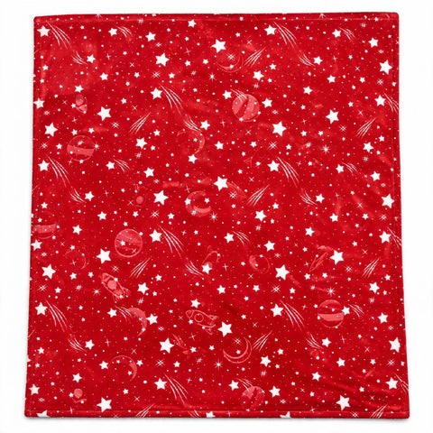 A square red blanket or throw featuring a white space-themed print with stars, shooting stars, planets, and space dust, shown flat against a white background.