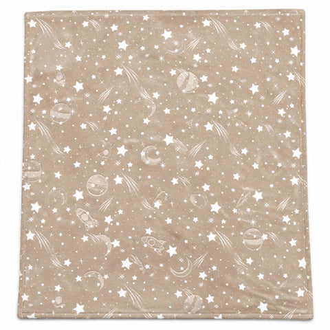 A square blanket with a beige background featuring a white space-themed pattern of stars, planets, and shooting stars.