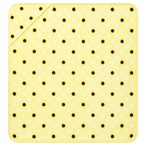 A square yellow cloth or mat with a repeating pattern of small dark brown and white polka dots, shown flat against a white background.