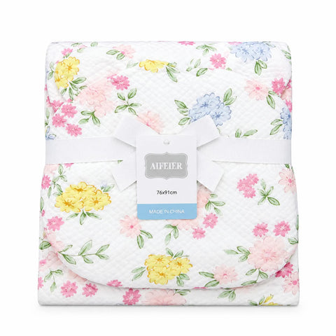 A folded baby blanket with a white background and a pastel floral print featuring pink, yellow, and blue flowers with green leaves. It is wrapped in a white ribbon with a central tag that reads 'AIFFIER' and '76*91cm MADE IN CHINA'.