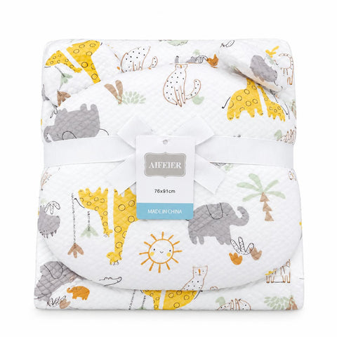 A folded baby blanket with a safari animal print, wrapped in a white ribbon with a brand tag. The blanket features yellow giraffes, gray elephants, and a sun on a white background.