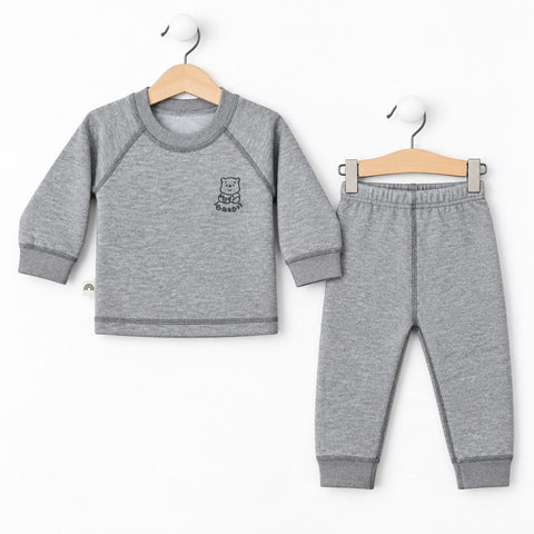 A toddler two-piece clothing set consisting of a heather gray long-sleeve top with a small bear graphic on the chest and matching heather gray jogger pants, displayed on wooden hangers against a white background.