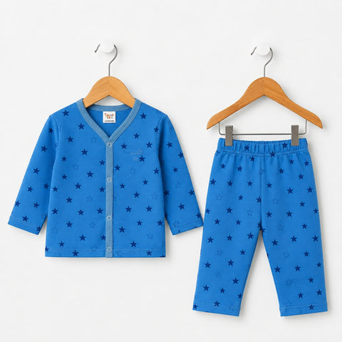 A two-piece baby pajama set consisting of a blue long-sleeve cardigan and matching pants, both decorated with a dark blue star pattern, hanging on wooden hangers against a plain white wall.