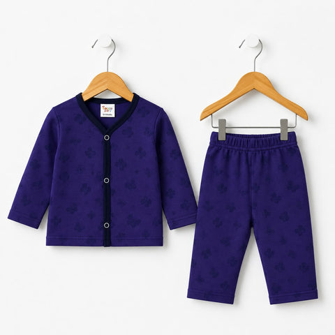 A baby clothing set consisting of a long-sleeve cardigan and matching pants, both in deep purple with a subtle tonal pattern, hanging on wooden hangers against a plain white background.