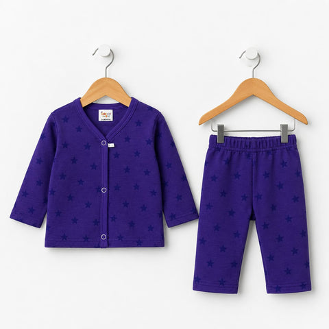 A two-piece baby pajama set in purple, featuring a long-sleeve button-front cardigan and matching shorts, both decorated with a subtle dark star pattern. The set is displayed on wooden hangers against a clean white background.