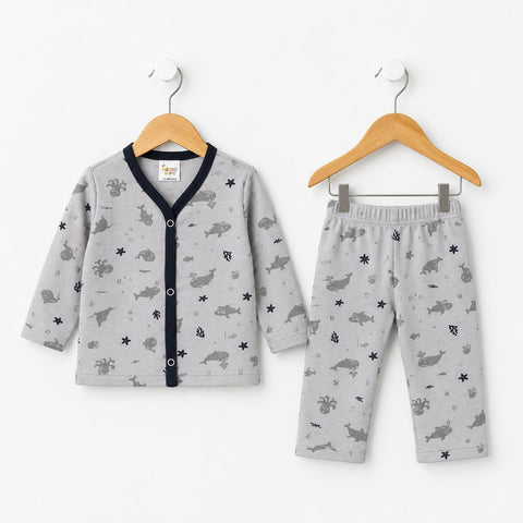 Baby two-piece pajama set including a long-sleeve cardigan and matching pants, displayed on wooden hangers against a white background. The set is light gray with a dark gray animal and star pattern, featuring a dark navy blue button-up front on the cardigan.