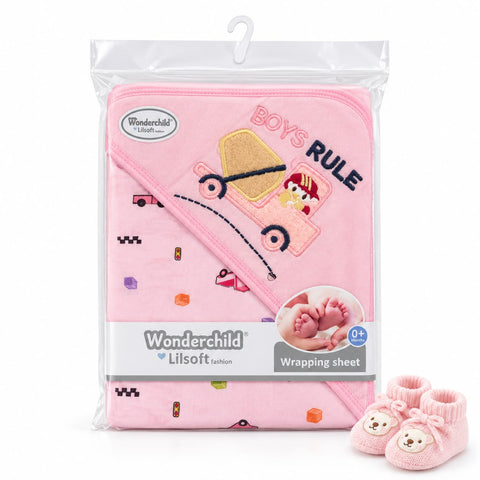 Wonderchild Lilsoft pink baby blanket with a 'BOYS RULE' truck applique, shown in its clear plastic packaging with a hanger, alongside a pair of matching pink booties.