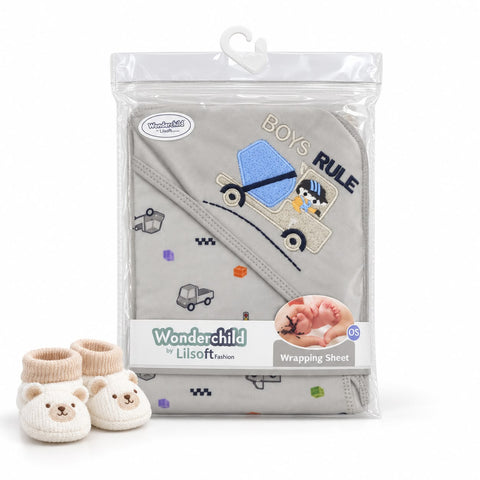 Wonderchild Lilsoft baby blanket in a clear plastic hanging package, featuring a light gray fabric with a blue and beige truck embroidery and the words 'BOYS RULE'. Two cream-colored bear face booties are placed in front on a white background.