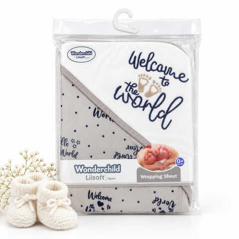 Wonderchild Lilsoft Welcome to the World baby wrapping sheet in its clear plastic packaging, shown with a pair of cream knit baby booties on a white background.