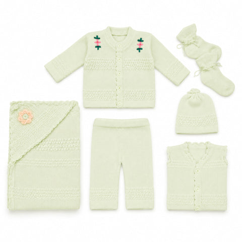 A 6-piece baby knit clothing set in pale mint green, featuring a long-sleeve cardigan with embroidered flowers, matching pants, a folded blanket with a flower applique, a beanie, booties, and a sleeveless vest, all arranged on a white background.