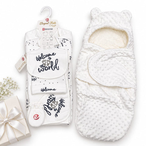 A baby gift set featuring a white quilted bodysuit with 'Welcome to the world' text and a matching white swaddle wrap with bear ears, displayed on a clean white background with a small gift box and baby's breath prop.