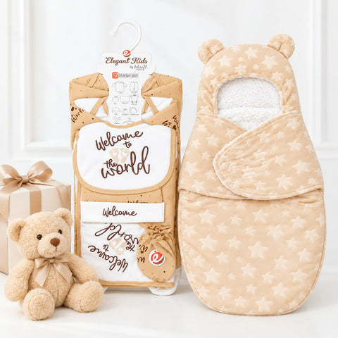 A baby wrap blanket and matching bib set by Elegant Kids by Meigh, displayed with a small teddy bear. The set features a beige and cream star-patterned wrap blanket with bear ears and a matching bib, shown next to its retail packaging and a plush teddy bear on a white background.