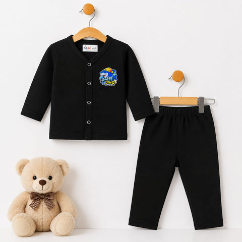 A two-piece baby clothing set consisting of a black long-sleeve button-front cardigan top and matching black pants, displayed on wooden hangers against a white background, with a beige teddy bear toy at the bottom left.