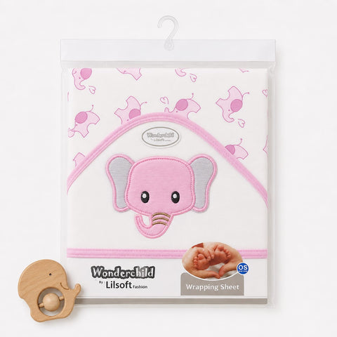 Wonderchild by Lilsoft baby wrapping sheet in a clear plastic hanging package, featuring a pink elephant applique on a white background with pink elephant prints. A small wooden teething ring is placed in front on a clean white background.