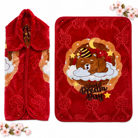 A red plush fleece blanket shown in two views: folded to show the hooded zipper closure and flat to display a cartoon bear sleeping on a cloud with stars and the words 'Dream Day'.