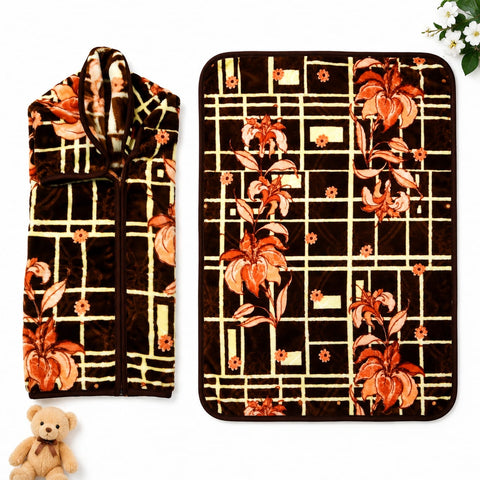A two-piece fleece blanket set featuring a zippered hooded blanket and a matching flat throw blanket, both with a dark brown background, cream grid pattern, and orange floral motifs. Shown on a white background with a small teddy bear and white flowers as props.