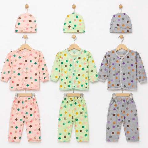 Three baby clothing sets displayed on wooden hangers against a white background, each set including a hat, long-sleeve top, and pants in soft pastel colors with multicolored polka dots. The sets are pink, mint green, and light gray.