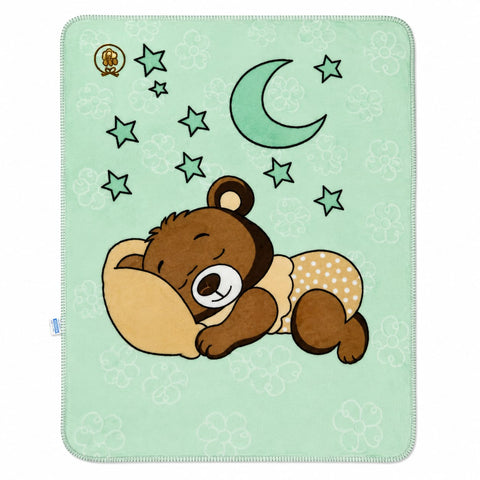 A square baby blanket with a mint green background, featuring a cartoon sleeping brown bear, a crescent moon, and stars. The blanket has a white border and a small gold logo in the top-left corner.