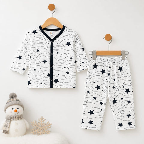 A baby two-piece outfit set consisting of a long-sleeve cardigan and matching pants, displayed on wooden hangers against a white wall. The set features a white base with black wavy lines and scattered black stars, with a black trim along the front button placket of the cardigan.