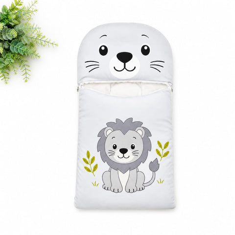 A white baby sleeping bag or pouch with a cartoon lion design on the front and a matching animal face cutout at the top, shown on a white background with a small green plant in the upper left corner.