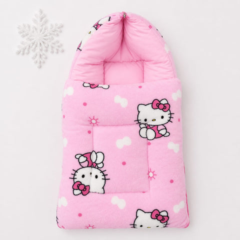 A pink quilted baby footmuff featuring Hello Kitty cartoon prints, shown on a clean white background with a decorative white snowflake in the upper left corner.