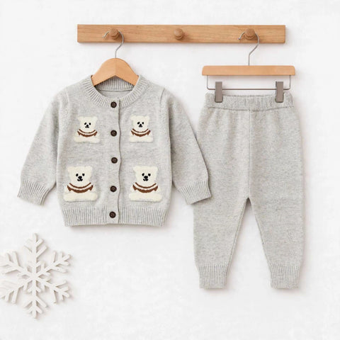 A baby clothing set consisting of a light gray knit cardigan sweater and matching jogger pants, displayed on wooden hangers against a white background. The cardigan features three cream-colored bear patches with brown details on the front.