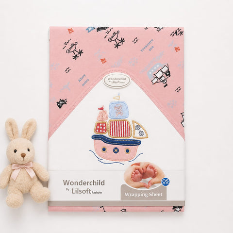 A pink baby wrapping sheet with a printed pirate ship design and small text reading 'Wonderchild by Lilsoft Fashion' and 'Wrapping Sheet,' shown on a white background with a small plush bunny beside it.