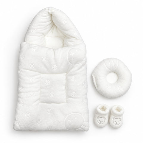A white baby sleep bag set with a matching circular neck pillow and two small booties, photographed on a clean white background.
