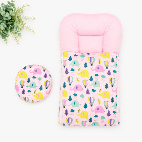 A baby travel seat cover set featuring a pink padded insert with a colorful elephant and hot air balloon print, shown alongside a matching round cup holder on a white background with a small green plant prop.