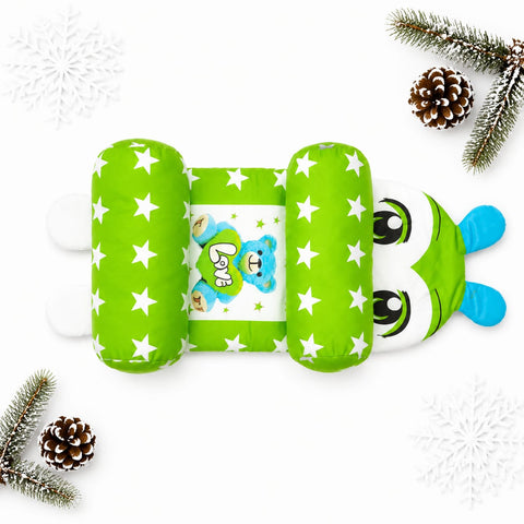 A green inflatable baby belly support cradle with white stars, featuring a cartoon bear design in the center and a frog face on the side, displayed on a white background with decorative pine branches and snowflakes.