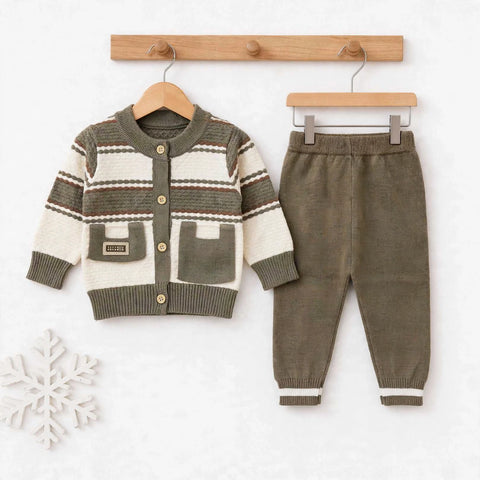 A baby clothing set featuring a knit cardigan sweater and matching pants, displayed on wooden hangers against a white background. The cardigan has a cream and olive green color-blocked pattern with brown stripes, and the pants are olive green with white stripes at the cuffs.