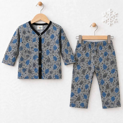 A two-piece baby clothing set consisting of a long-sleeve cardigan and matching pants, displayed on wooden hangers against a white textured background. The set features a gray base with blue and black spotted patterns, a black trim on the cardigan's collar and button placket, and an elastic waistband on the pants.