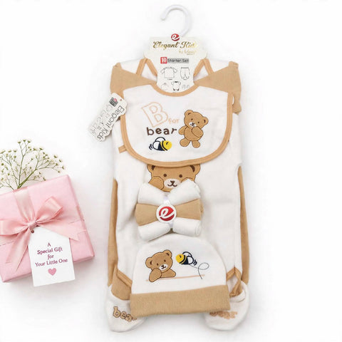 A baby footed sleeper set from Elegooz Kids, featuring a cream and tan bib, matching footed sleeper, and hood, decorated with cute teddy bear and bee illustrations. The set is displayed on a white background next to a pink gift box with a bow and tag.