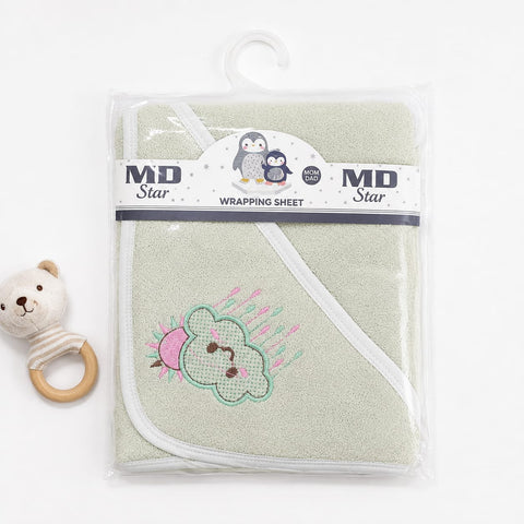 A packaged baby hooded towel in a pale sage green color, featuring a stitched cloud and bird design on the front. The product is wrapped in a clear plastic sleeve with a white and navy MD Star brand label and hanging tab, set against a plain white background with a small plush toy rattle prop on the left.