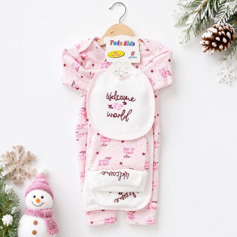 A baby sleep suit set with a bib, hanging on a wooden hanger. The set includes a light pink long-sleeve sleep suit with small dark pink star and snowman patterns, a white bib with 'Welcome to the world' printed in dark pink, and a matching white foot warmer.