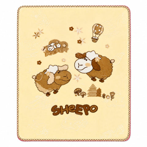 A square cream-colored blanket or throw featuring a cute cartoon design of brown sheep, a hot air balloon, mushrooms, and the word 'SHEEPS' in brown lettering at the bottom.