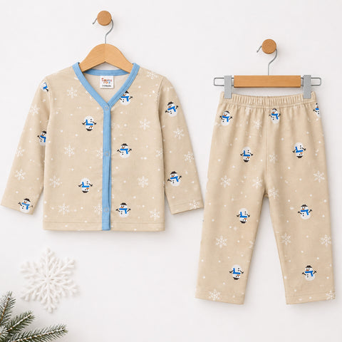 A two-piece baby pajama set hanging on wooden hangers against a white wall. The set includes a long-sleeve V-neck cardigan and matching pants in beige fleece with a snowman and snowflake print, accented by a light blue trim on the cardigan.