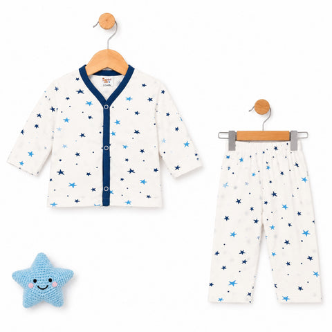 Baby two-piece pajama set featuring a short-sleeve cardigan top and matching pants, both in an off-white fabric with a star pattern in navy and light blue. The cardigan has a navy blue V-neck trim and button placket.