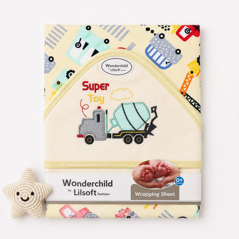Wonderchild Lilsoft baby wrapping sheet with a construction-themed design, featuring a cement mixer truck and colorful toy patterns on a cream background, shown with a small crochet star toy.