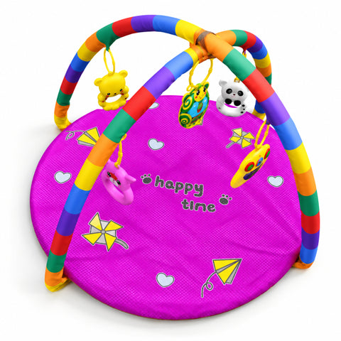 A baby activity gym mat in bright pink with rainbow-colored striped arches and hanging toys, including a yellow bear, green patterned bag, white panda, pink frog, and yellow kite, on a white background.
