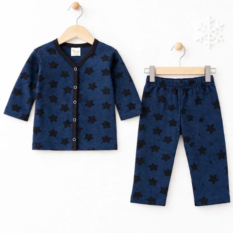 A two-piece baby clothing set consisting of a long-sleeve cardigan and matching pants, both in navy blue with a black star pattern, hanging on wooden hangers against a white background.