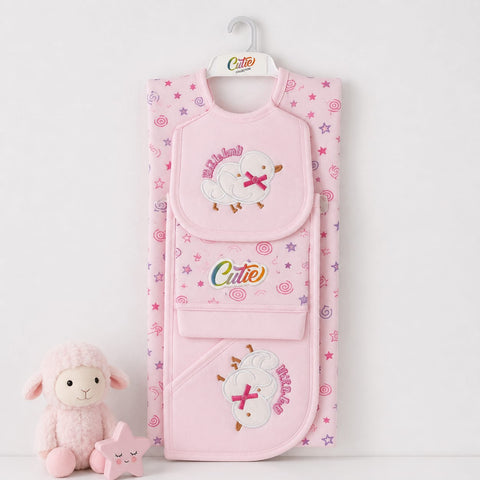 A pink baby bib and matching footed crib blanket set with embroidered sheep and stars, hanging on a white hanger with a small plush sheep toy beside it on a white background.