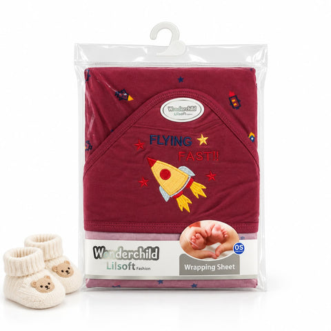 A packaged baby wrap sheet set by Wanderchild Lilsoft Fabrics in maroon, featuring a rocket embroidery design and 'FLYING FAST!!' text, shown with a pair of cream booties on a white background.