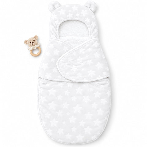 A white baby swaddle wrap with a star pattern, featuring a hood with bear ears and a matching wooden teether with a plush bear face, shown on a plain white background.