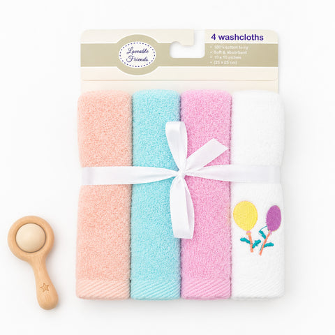 Four folded washcloths in pastel peach, aqua, pink, and white, tied with a white ribbon and displayed on a white background with a small wooden toy spoon. The package header reads 'Lovely Friends 4 washcloths'.