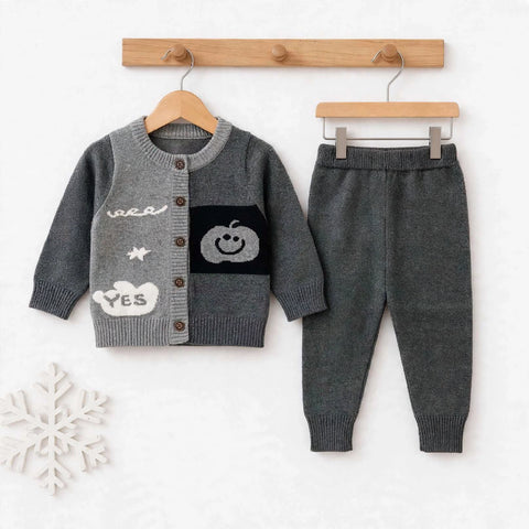 A baby boy's two-piece knit outfit set consisting of a gray cardigan sweater with white and black knit details and matching dark gray pants, displayed on wooden hangers against a white background.